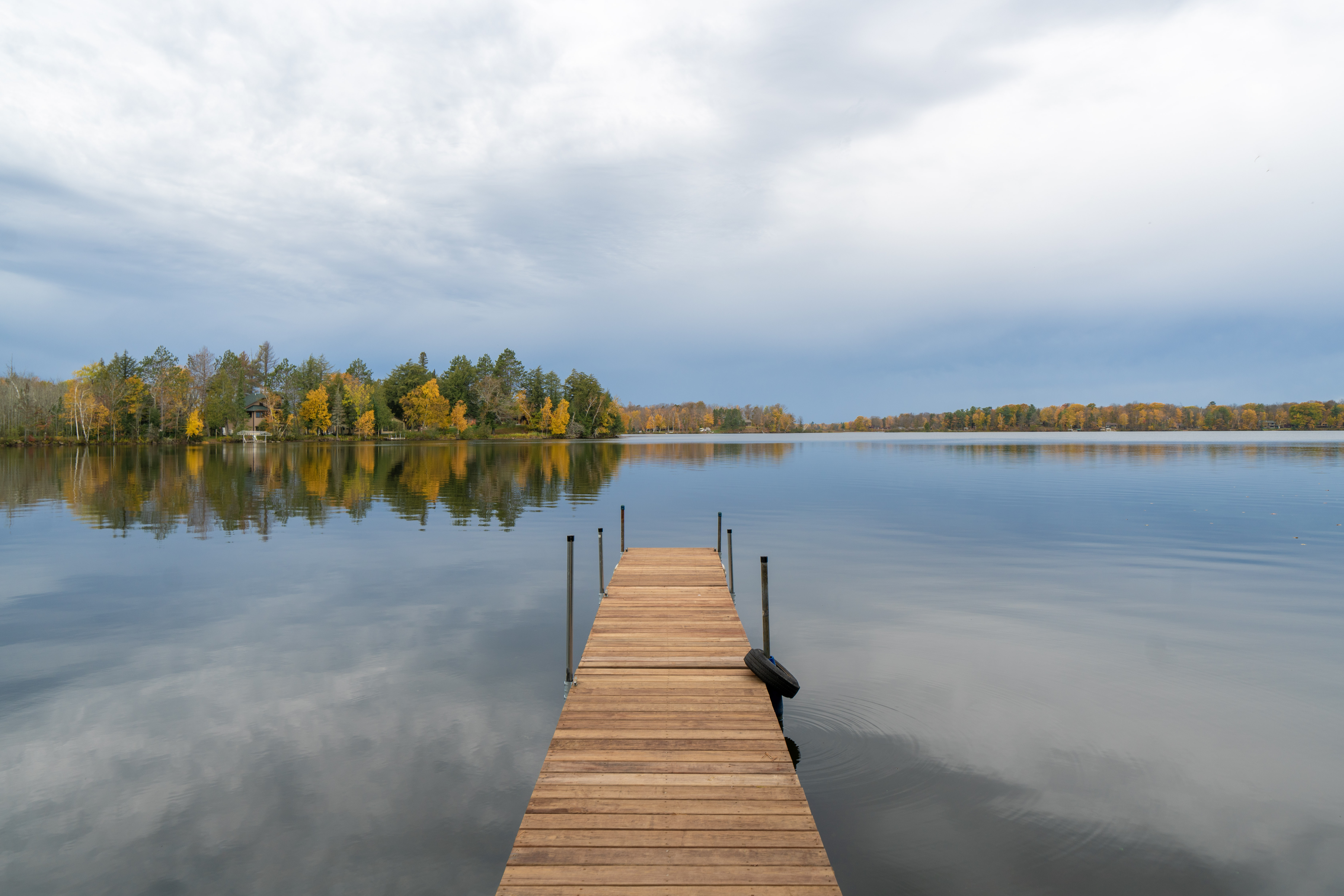 Telemark Northwoods Lodging - Lakefront Water view from Telemark Northwoods Lodging in Cable, Wisconsin, with late‑autumn foliage and golden light.